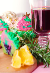 Christmas cupcakes - homemade cupcakes with spinach and ricotta cream decorated with green and pink cream. Christmas and New Year dessert. Sugar free, gluten free pastry. Cup of mulled wine.