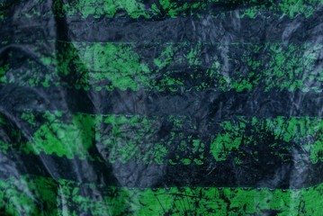 black green plastic texture from a piece of shabby cellophane