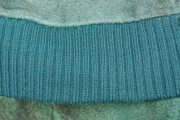 green fabric texture from a piece of old clothes