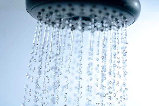 Shower head and falling water drops. © Janis Smits