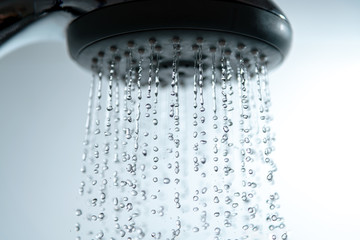 Naklejka na ściany i meble Shower head and falling water drops.