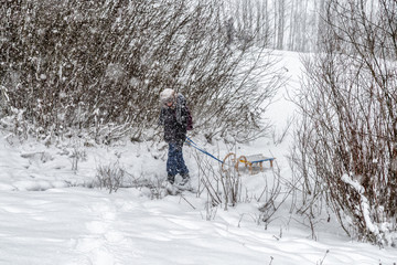 Boy pulling a sled