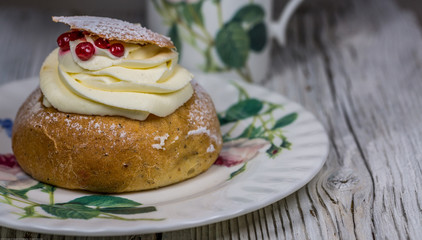 Swedish Semla Cake with Cranberries on Dish.Close-Up