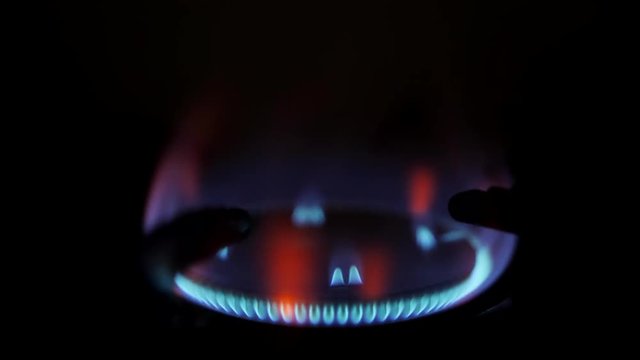 Stove Burner Fire Ignition. Blue Cooking Flame 4K Macro Slow Motion Footage.