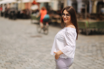Fototapeta premium Attractive young lady stand in centre of the city