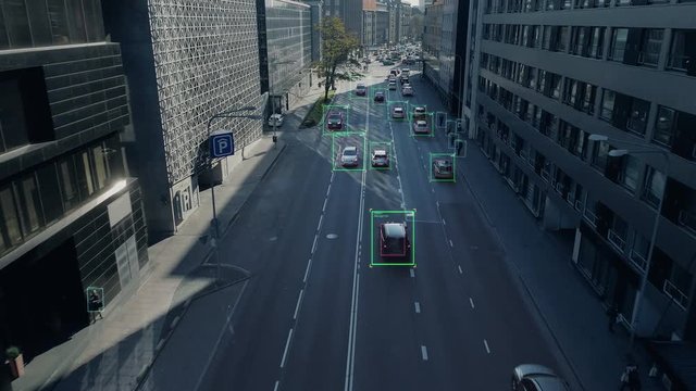Aerial Drone Shot: Autonomous Self Driving Cars Moving Through City. Concept: Artificial Intelligence Scans Cars and Pedestrians, Following Movement and Showing Data.