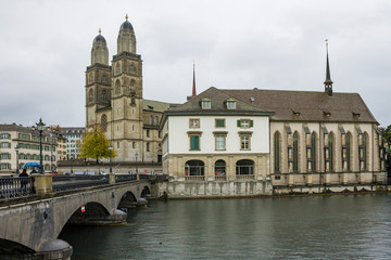 ZURICH, SWITZERLAND - OCT 130th, 2018: View of Grossmunster and Zurich old town from Limmat river. The Grossmunster is a Romanesque Protestant church in Zurich, Switzerland. Rainy weather in autumn. - 241738799