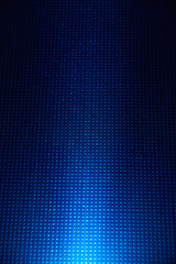 On a bright blue checkered background a white beam of light