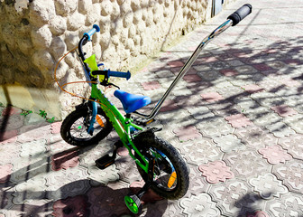 beautiful children multi-colored bicycle under the rays of the sun
