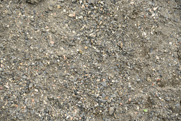 Textured background of crushed stones of asymmetric shape and sand