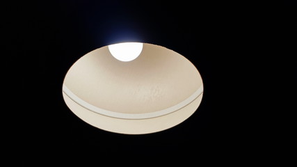 Lamp glowing in dark tone. Light shines down.  