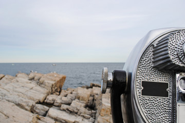 Beautiful panorama of rocky coast of Atlantic Ocean and stationary binocular