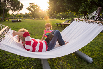 mom and a little daughter relaxing in a hammock