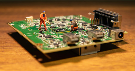 One worker model with digging fork on circuit board