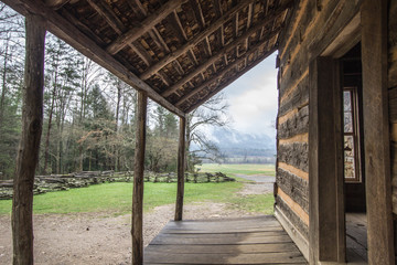 Tennessee Historic Log Cabin. Exterior and front porch of a pioneer log cabin in the Cades Cove valley of the Great Smoky Mountains National Park in Tennessee.