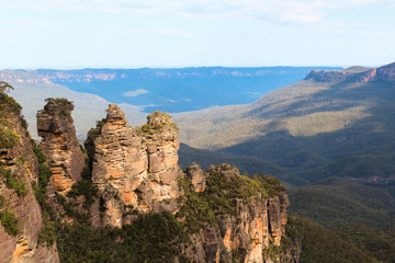 Naklejka na ściany i meble View of the Three Sisters in Katoomba with a valley of the Blue Mountains in the background (Sydney, New South Wales, Australia)