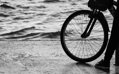 silhouette of bicycle wheel and the leg of human