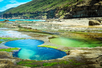 Picturesque Figure 8 Pools in the Royal National Park near Sydney filled with clear blue water on a summer day (Sydney, New South Wales, Australia)