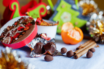 Variety of sweet food, chocolate candies and pralines on Christmas festive table. Winter holidays.