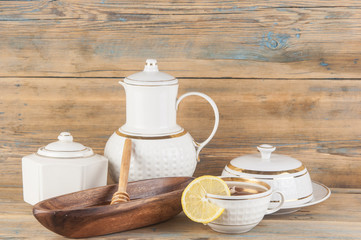 Fototapeta na wymiar Tea with lemon and honey on the wooden background