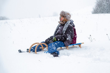 Fototapeta na wymiar Boy sitting on a sled
