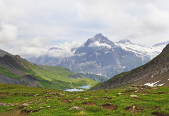 Alpine peaks landskape background. Bachalpsee lake, Grindelwald, Bernese highland. Alps, tourism, journey, hiking concept.
