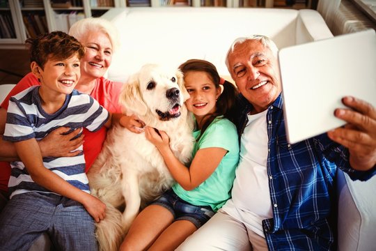 Grandparents And Grandchildren Taking A Selfie With Digital