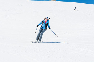Female back-country skier tackling a steep slope.
