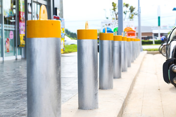 Stainless steel bollard barriers in front a shop prevent people for security. 