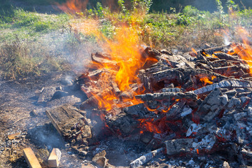 A large fire burning in the open.