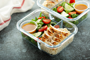 Meal prep lunch box containers with grilled chicken and fresh vegetables