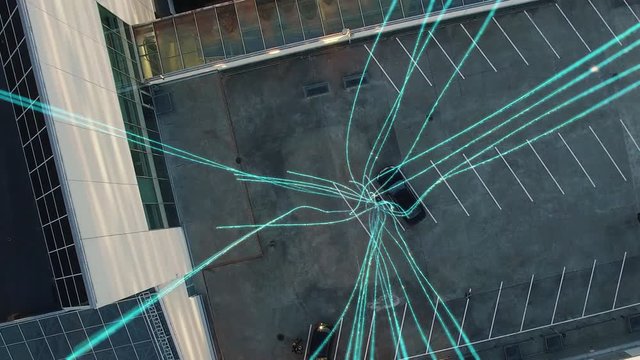 Big City Businessman Uses Smartphone, Stands on Skyscraper Roof: Visualization of Information Flows and Lines Flying from Mobile Phone into Global Network. Top Down Aerial Elevating Drone Shot.