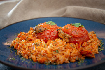 stuffed tomatoes with rice on a white plate