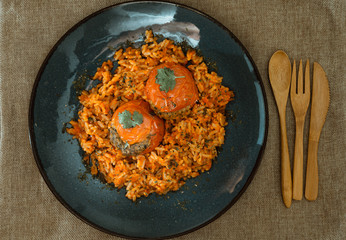 stuffed tomatoes with rice on a white plate