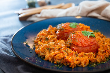 stuffed tomatoes with rice on a white plate