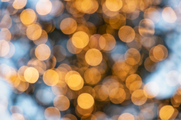 Fototapeta premium Blue and yellow Christmas lights defocused