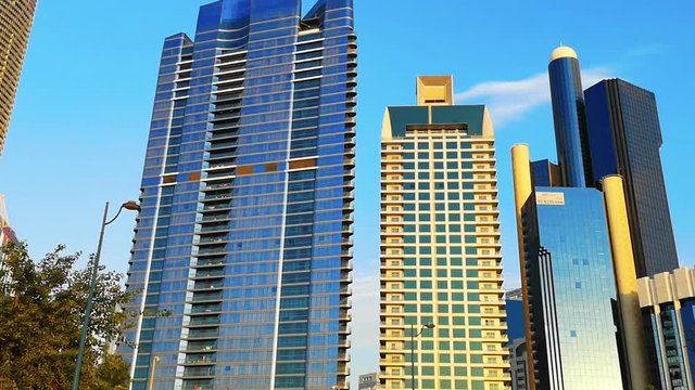 Beautiful view of Abu Dhabi city famous towers, buildings and parks at sunset from the corniche street