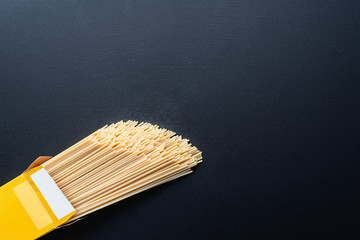 pack of spaghetti on black background