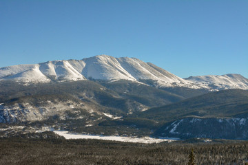 Snow covered rocky mountains surrounding the ski resort and valley in Breckenridge, Colorado.