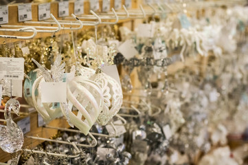 Sale of Christmas toys in the supermarket. Balls of different colors for the Christmas tree on the supermarket shelves. 