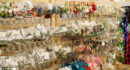 Sale of Christmas toys in the supermarket. Balls of different colors for the Christmas tree on the supermarket shelves. 