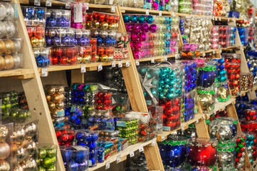 Sale of Christmas toys in the supermarket. Balls of different colors for the Christmas tree on the supermarket shelves. 