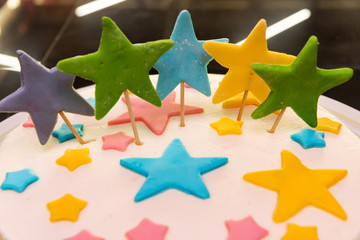 colorful stars decorate the cake, close-up