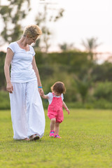 Fototapeta premium mother and little daughter playing at backyard