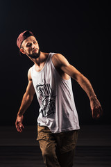 Fototapeta na wymiar Portrait of a bearded man a hip hop dancer or bboy in urban style clothes and with inscription 