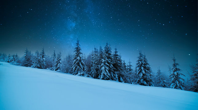Tatras Mountains in winter at night with falling stars, Poland
