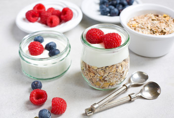 Healthy breakfast. Fresh raspberries and blueberries with yogurt and muesli.