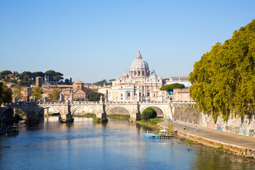 Fototapeta na wymiar Autumn in Rome with view of the Tiber river, the Sant Angelo Bridge and St. Peters cathedral in the far background