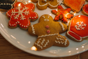 Gingerbread cookies on white dish with golden lights.