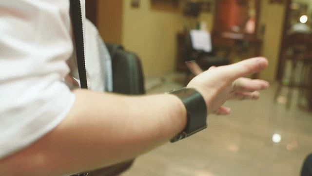 Barber or hairdresser turns scissors on finger close-up